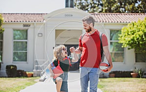 Dad and child go hand in hand. Beginning of lessons. Father walking son to school. Parent and pupil of primary school