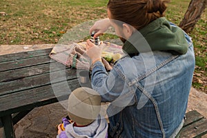 Dad and child have a picnic in the city park.