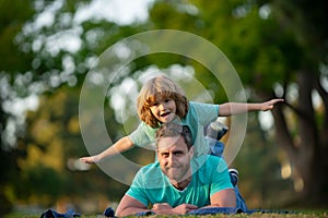 Dad and child having fun outdoors. Concept of healthy holiday and family activity.