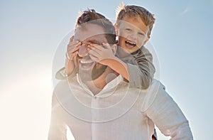 Dad, child and piggy back with covering eyes for game, playing and funny time in sunshine with love. Sun, sky and family