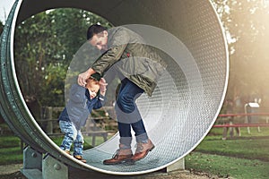 Dad, child and playing together in playground with happy laugh, trees and bonding in outdoor garden. Father, son and