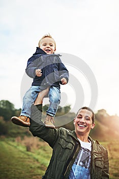 Dad, child and portrait of lifting in nature with happy laugh, fun bonding and outdoor garden. Father, son and playful