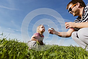 Dad and daughter blow bubbles