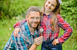 Dad and daughter blowing dandelion seeds. Keep allergies from ruining your life. Seasonal allergies concept. Outgrow