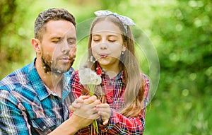 Dad and daughter collecting dandelion flowers. Keep allergies from ruining your life. Seasonal allergies concept