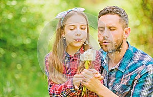 Dad and daughter collecting dandelion flowers. Keep allergies from ruining your life. Seasonal allergies concept photo