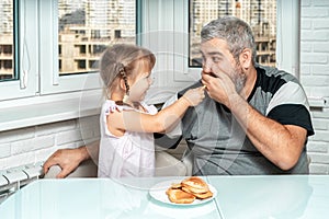 Dad and daughter eat pancakes and spend time together