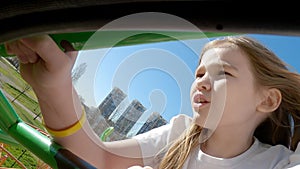 Dad and daughter go on thrill rides in amusement park. uncomfortable and painful