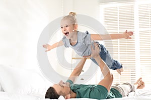 Dad and daughter having fun at home. Happy Father`s Day