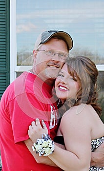 Dad and daughter hugging before she goes off to s