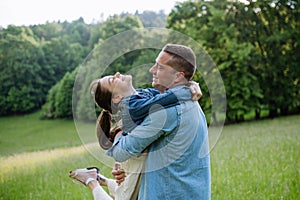 Dad with daughter, playing at meadow, hugging, having fun. Concept of fathers's Day and fatherly love.