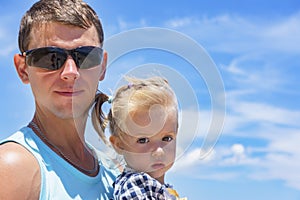 Dad and daughter playing on the promenade by the sea. young man, little girl