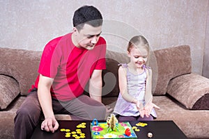 Dad and daughter playing table game