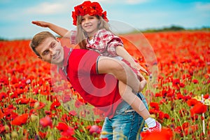 Dad and daughter in a poppy field