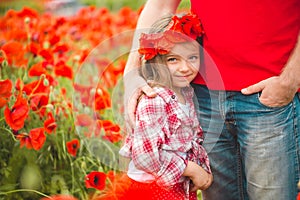 Dad and daughter in a poppy field