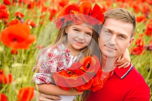 Dad and daughter in a poppy field