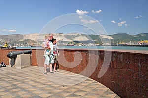 Dad, daughter and son walk along the embankment of Novorossiysk