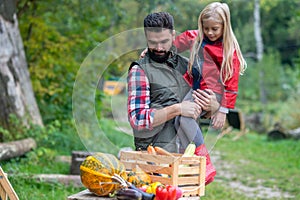 Dad and daughter spending time on a farm sorting the vegetables