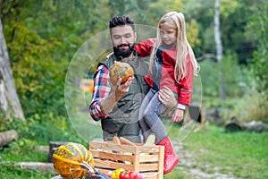 Dad and daughter spending time on a farm sorting the vegetables