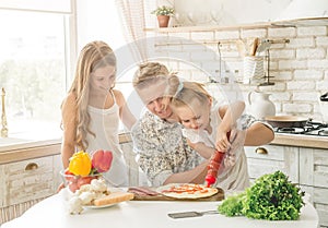 Dad with daughters preparing pizza