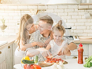 Dad with daughters preparing pizza