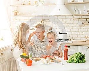 Dad with daughters preparing pizza