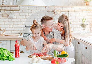 Dad with daughters preparing pizza