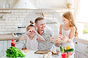 Dad with daughters preparing pizza