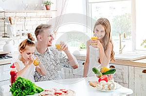 Dad with daughters preparing pizza