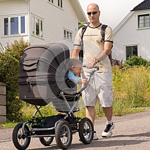 Dad drives his son in baby carriages