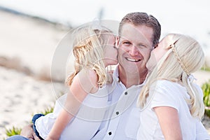 Dad Getting Kisses from His Cute Daughters photo