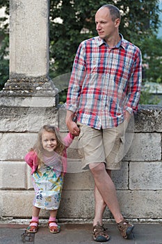 Dad with happy daughter individually full length street portrait photo