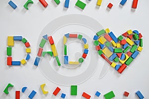 DAD and a heart with colorful wooden toy blocks