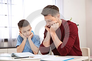 Dad helping his son with difficult homework assignment