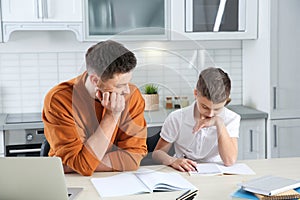 Dad helping his son with difficult homework assignment