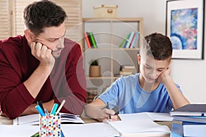 Dad helping his son with difficult homework assignment