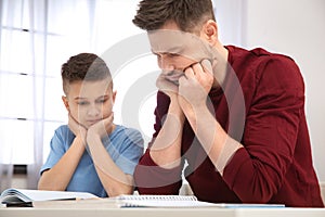 Dad helping his son with difficult homework assignment