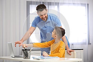 Dad helping his son with homework