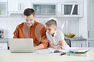 Dad helping his son with homework