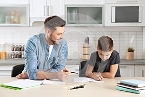 Dad helping his son with homework