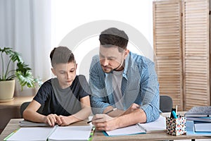 Dad helping his son with homework