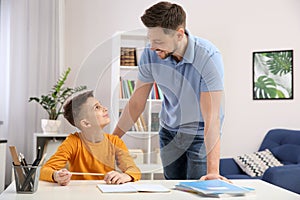 Dad helping his son with homework