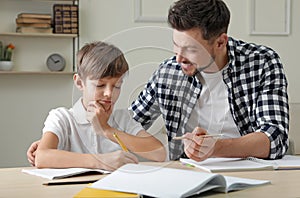 Dad helping his son with school assignment