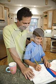 Dad helping son with homework.