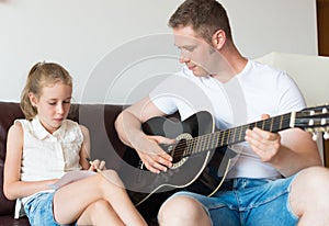 Dad and his daughter compose a song.