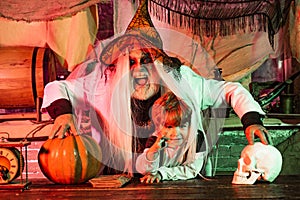Dad and his kid in carnival costumes on Halloween background. Happy family father and child in costumes on a celebration