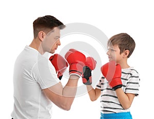 Dad and his son with boxing gloves on white