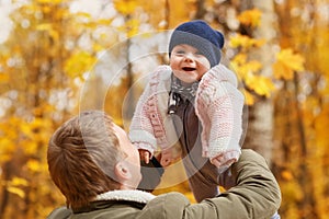 Dad holding baby girl in hands