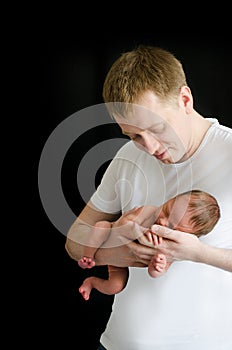 Dad holding a newborn baby