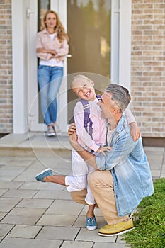 Dad hugging his daughter before she goes to school